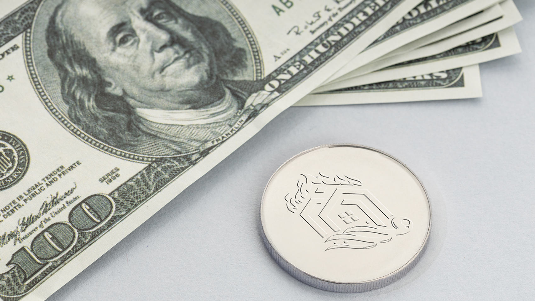 Litecoin coin and a pile of US dollar banknotes. Blockchain money versus fiat money concept