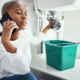Phone call, anxiety and plumbing with black woman and sink for maintenance, construction and leak. .