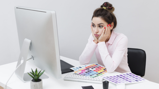 defeated-woman-sitting-desk-looking-computer