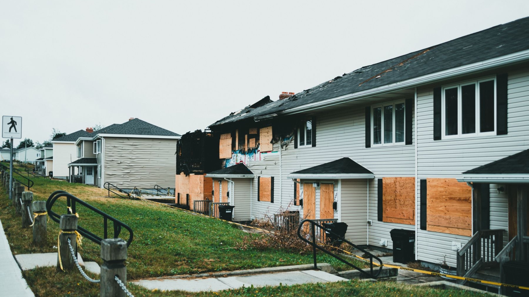 Fire-damaged apartment building with boarded windows