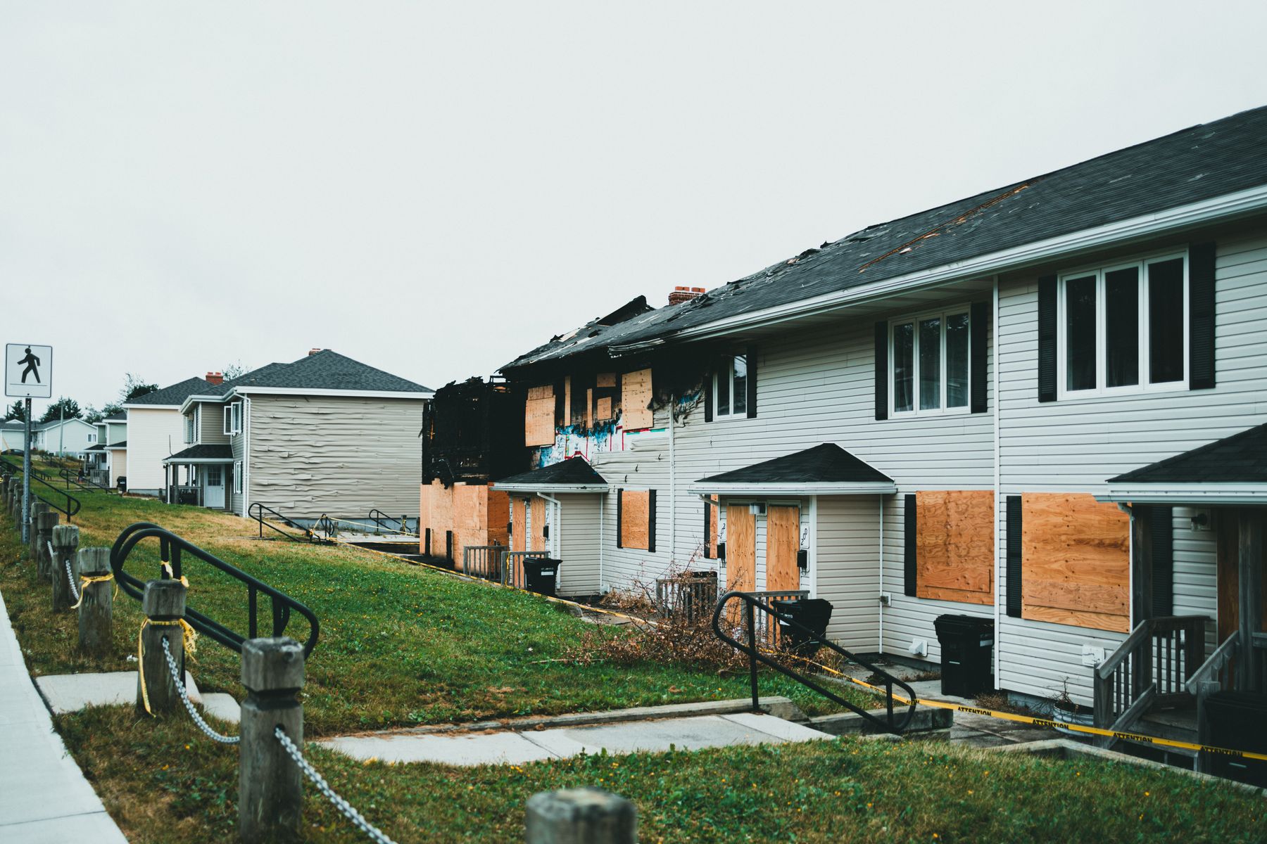 Fire-damaged apartment building with boarded windows